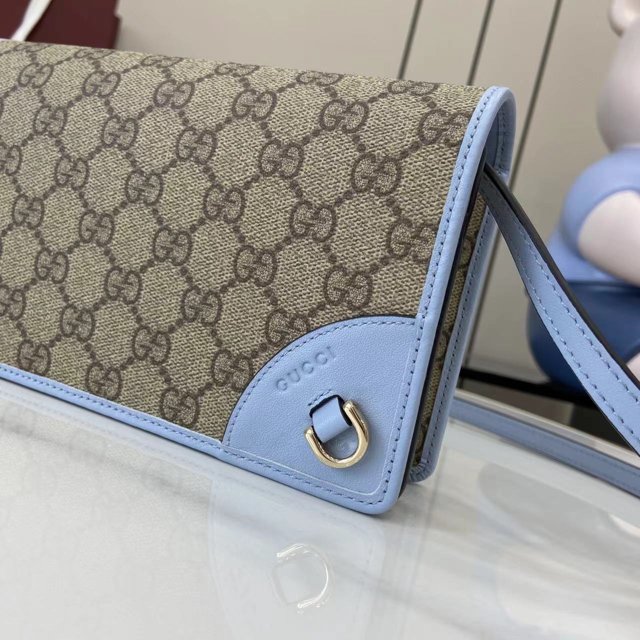 Gucci GG Emblem wallet with leather strap