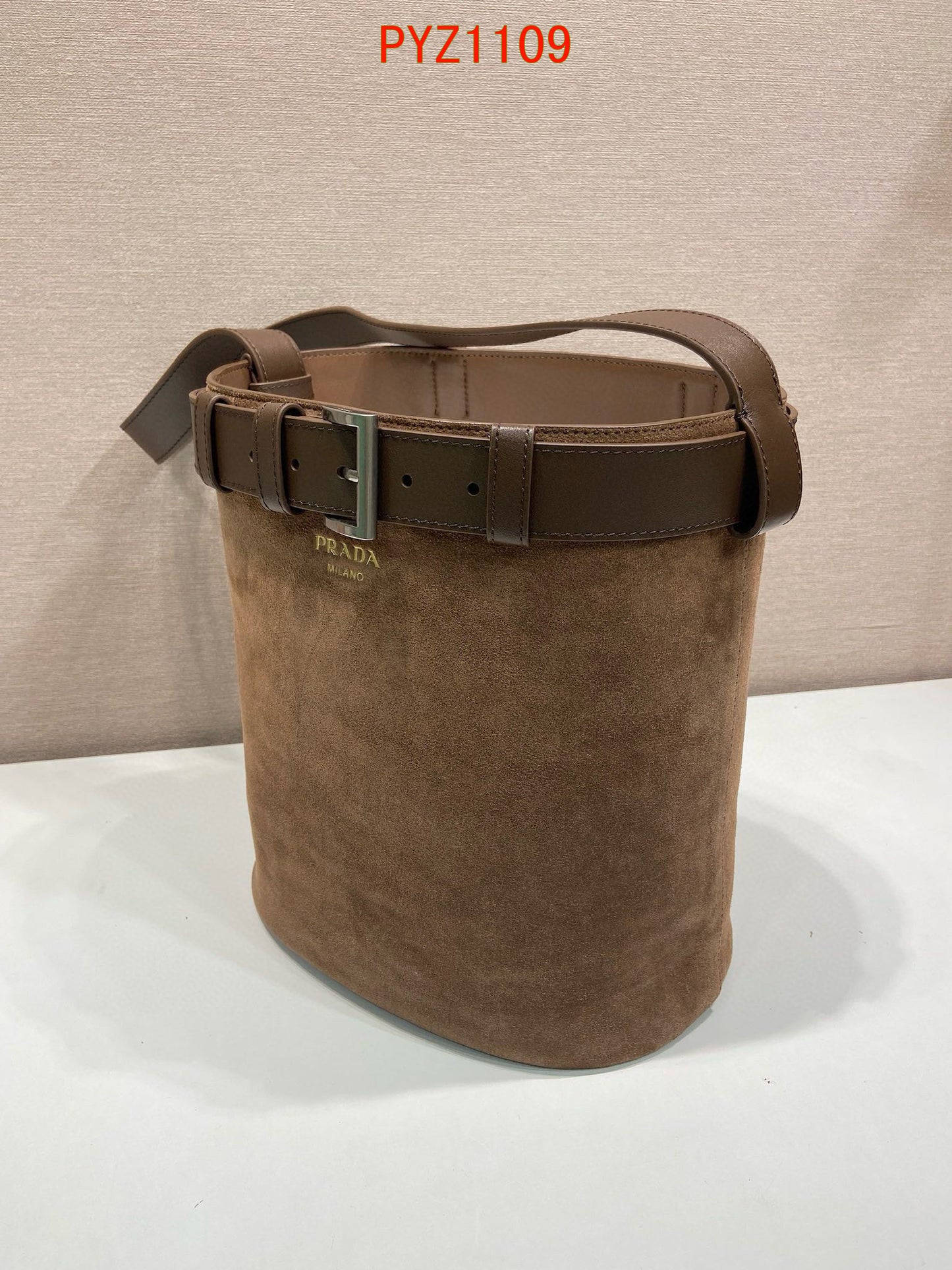 Prada Buckle suede bucket bag with jeweled belt