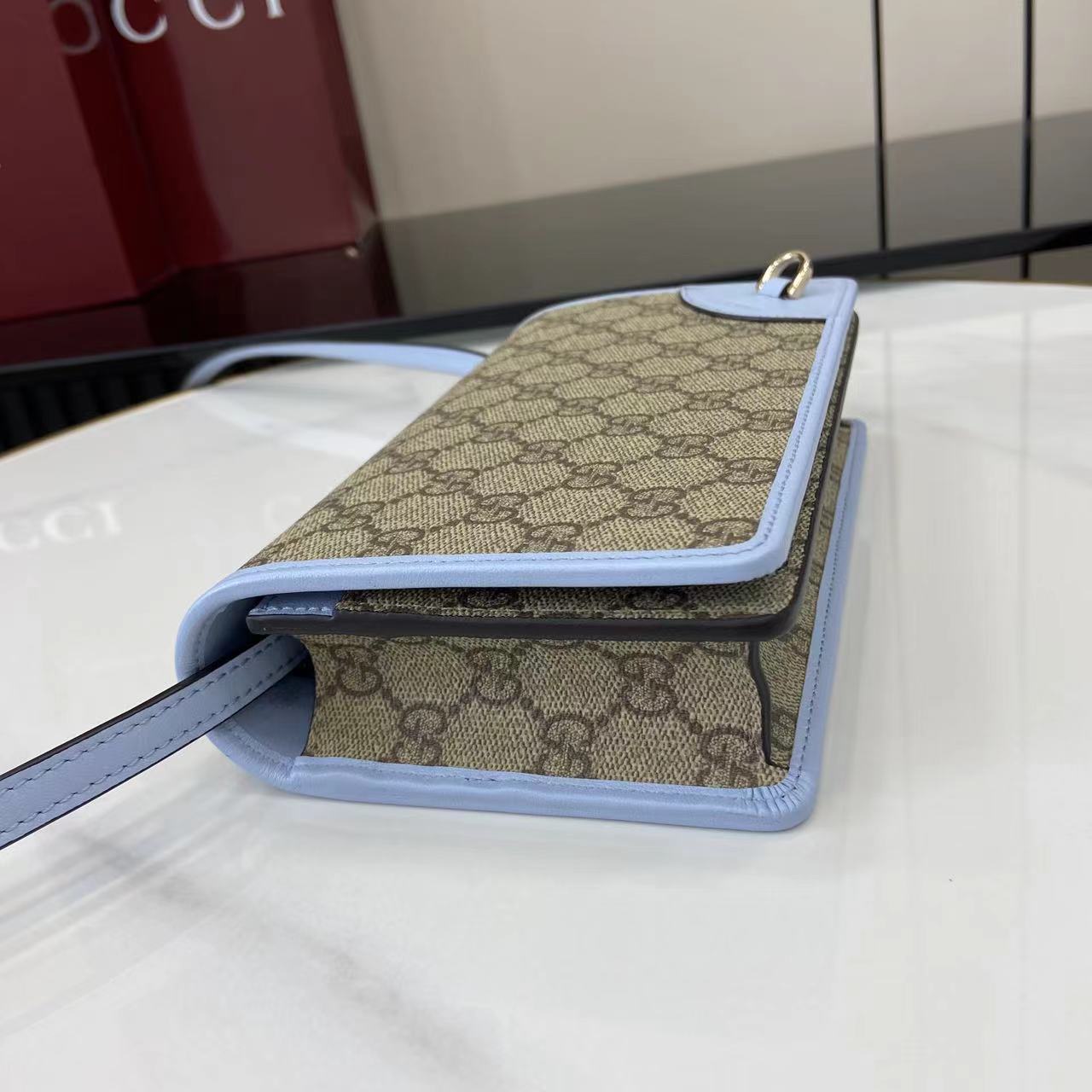 Gucci GG Emblem wallet with leather strap