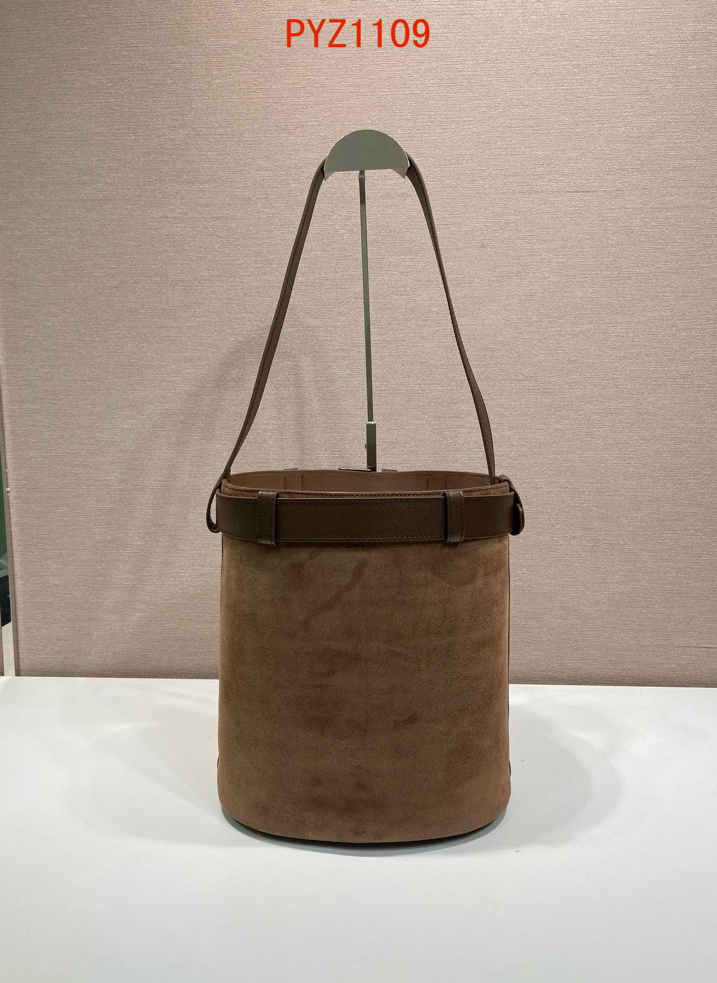 Prada Buckle suede bucket bag with jeweled belt