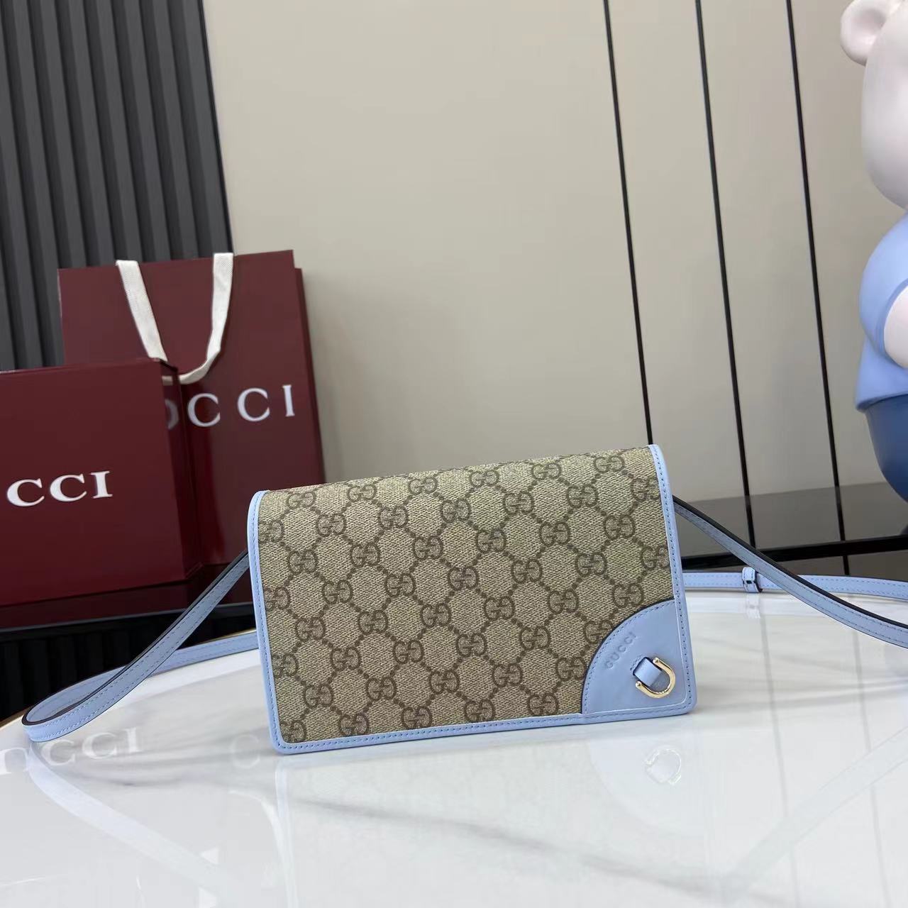 Gucci GG Emblem wallet with leather strap