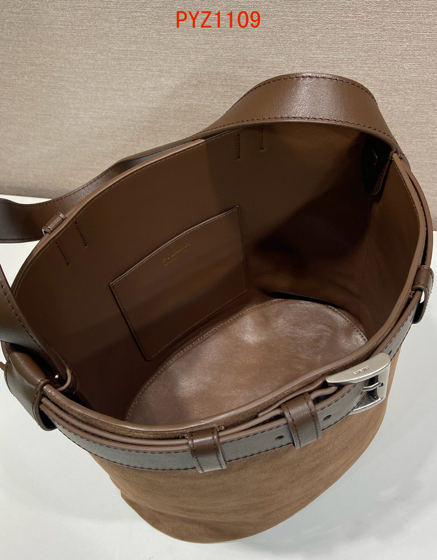 Prada Buckle suede bucket bag with jeweled belt