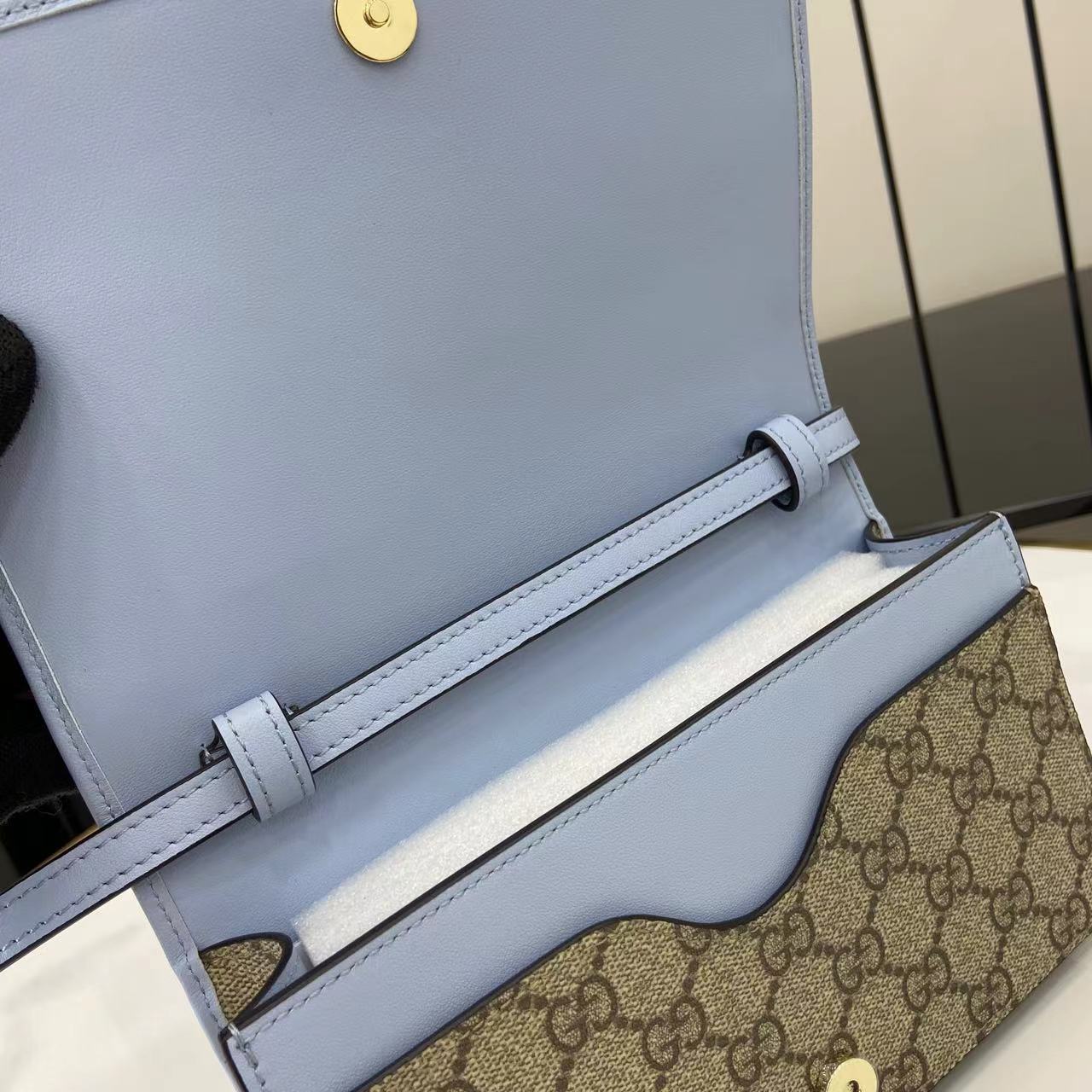 Gucci GG Emblem wallet with leather strap