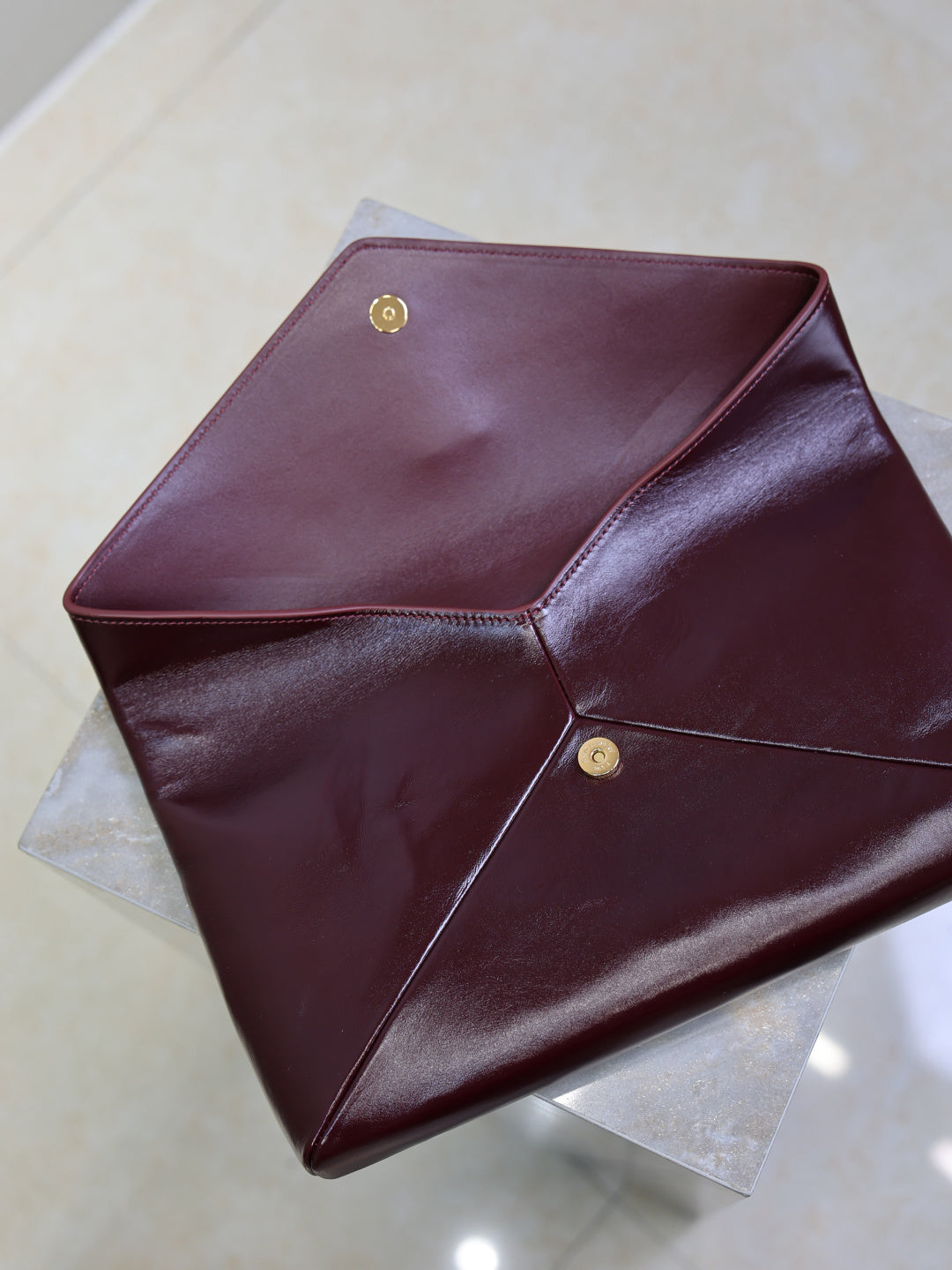 YSL CASSANDRE large envelope pouch in shiny leather