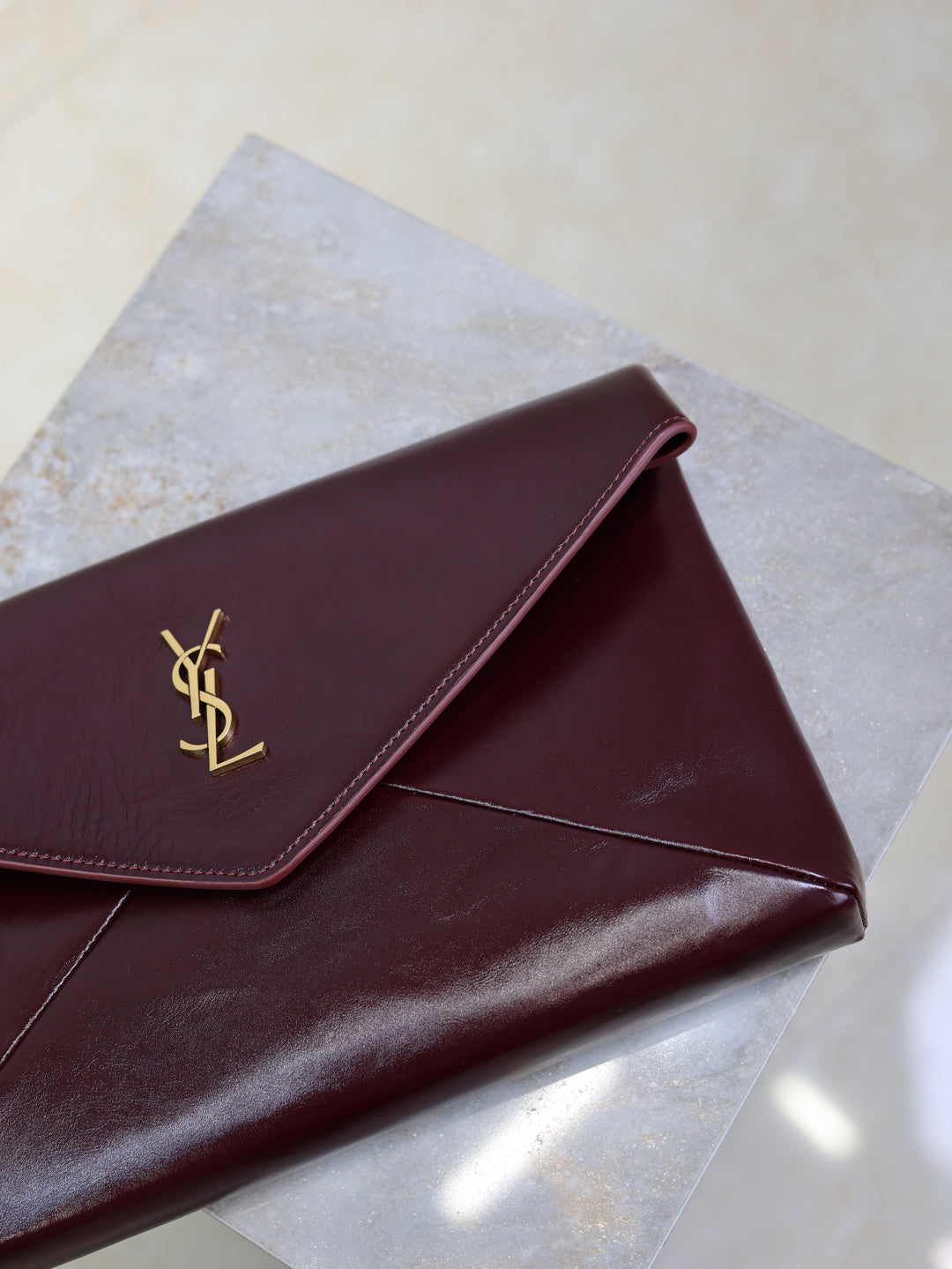 YSL CASSANDRE large envelope pouch in shiny leather