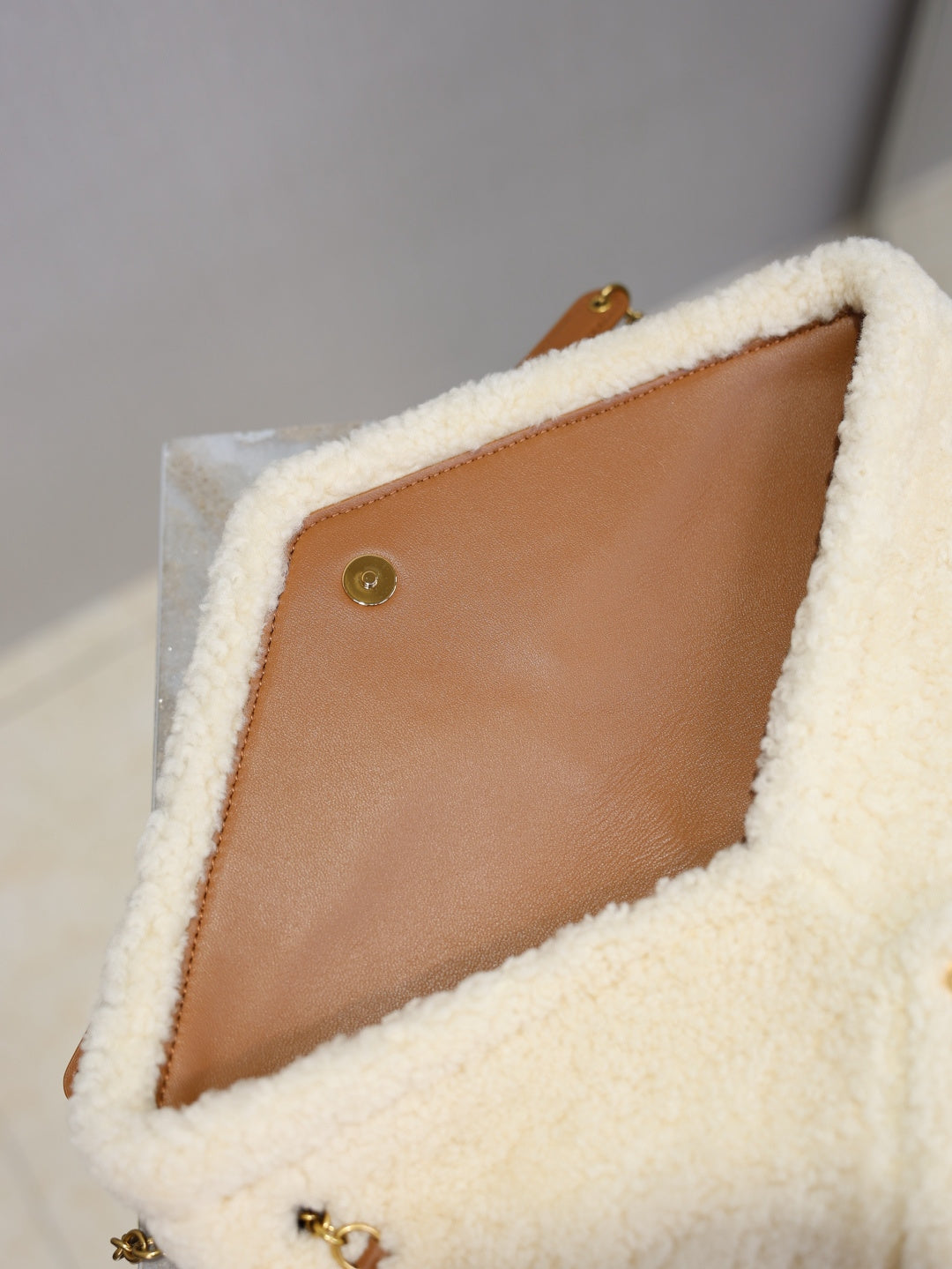 YSL CASSANDRE large pouch on chain in shearling