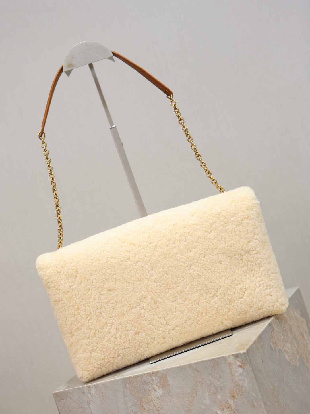 YSL CASSANDRE large pouch on chain in shearling